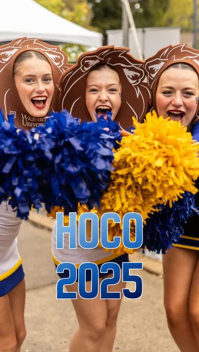 Three cheerleaders holding yellow and blue pom poms and wearing foam lion manes; on top of the image it says "HOCO 2025"