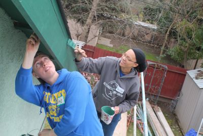 student and faculty volunteering on alternative spring break