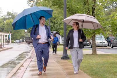 New trustee Domenic Colasante and Vice President Katie Herschede walk across campus.