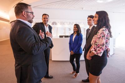 Widener students talk with leaders and Widener alumni in the Comcast building.