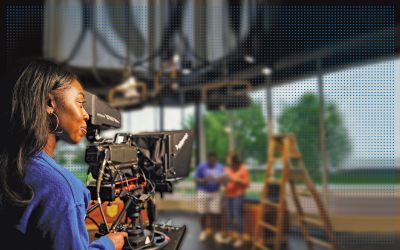 Communication studies students behind camera in television studio