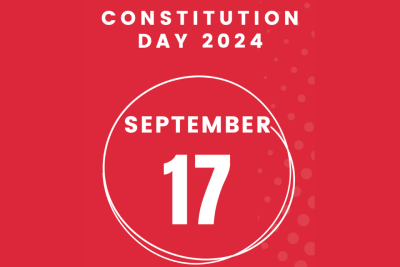 White text on a red background promoting a constitution day event