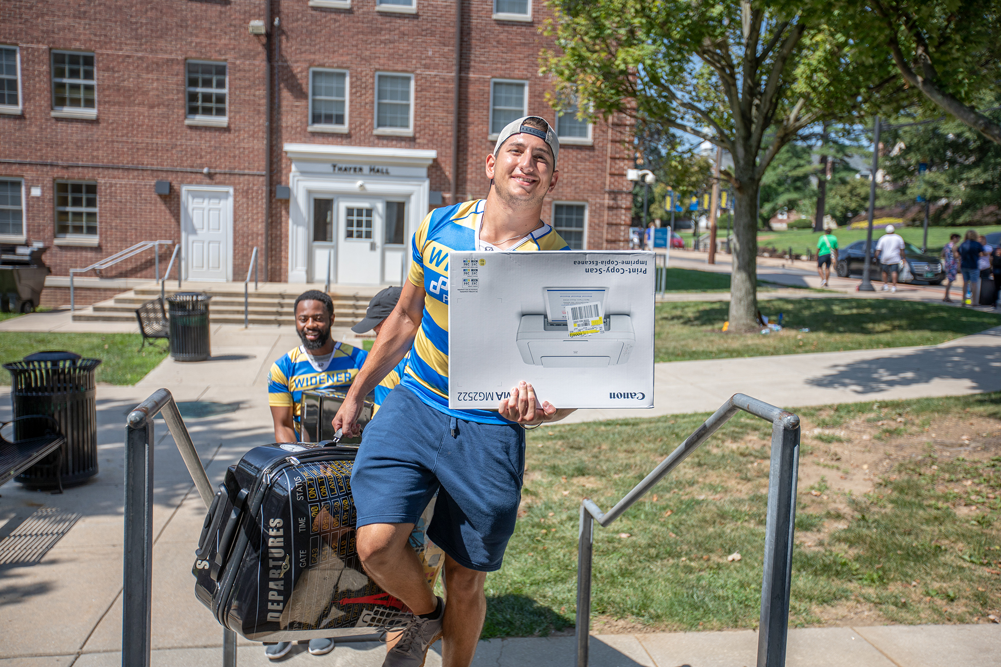 Rugby players help freshmen move their belongings into residence halls