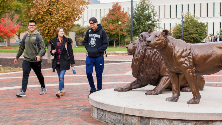 Students walking past Pride statues on Widener Campus