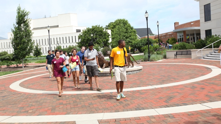 Widener tour in summer 710x400 Group of students walking across Widener's campus in shorts and t-shirts