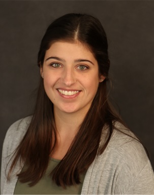 A headshot of Lauren Bishop wearing a tan sweater 