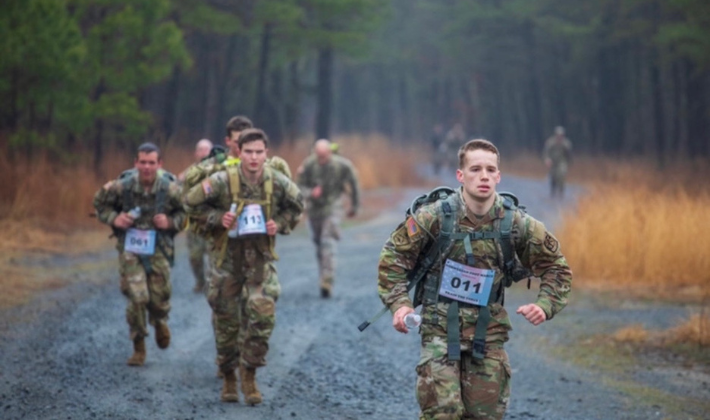 rotc mag 710x400 Uniformed members of the Army run through a fogge forrest carrying large backpacks
