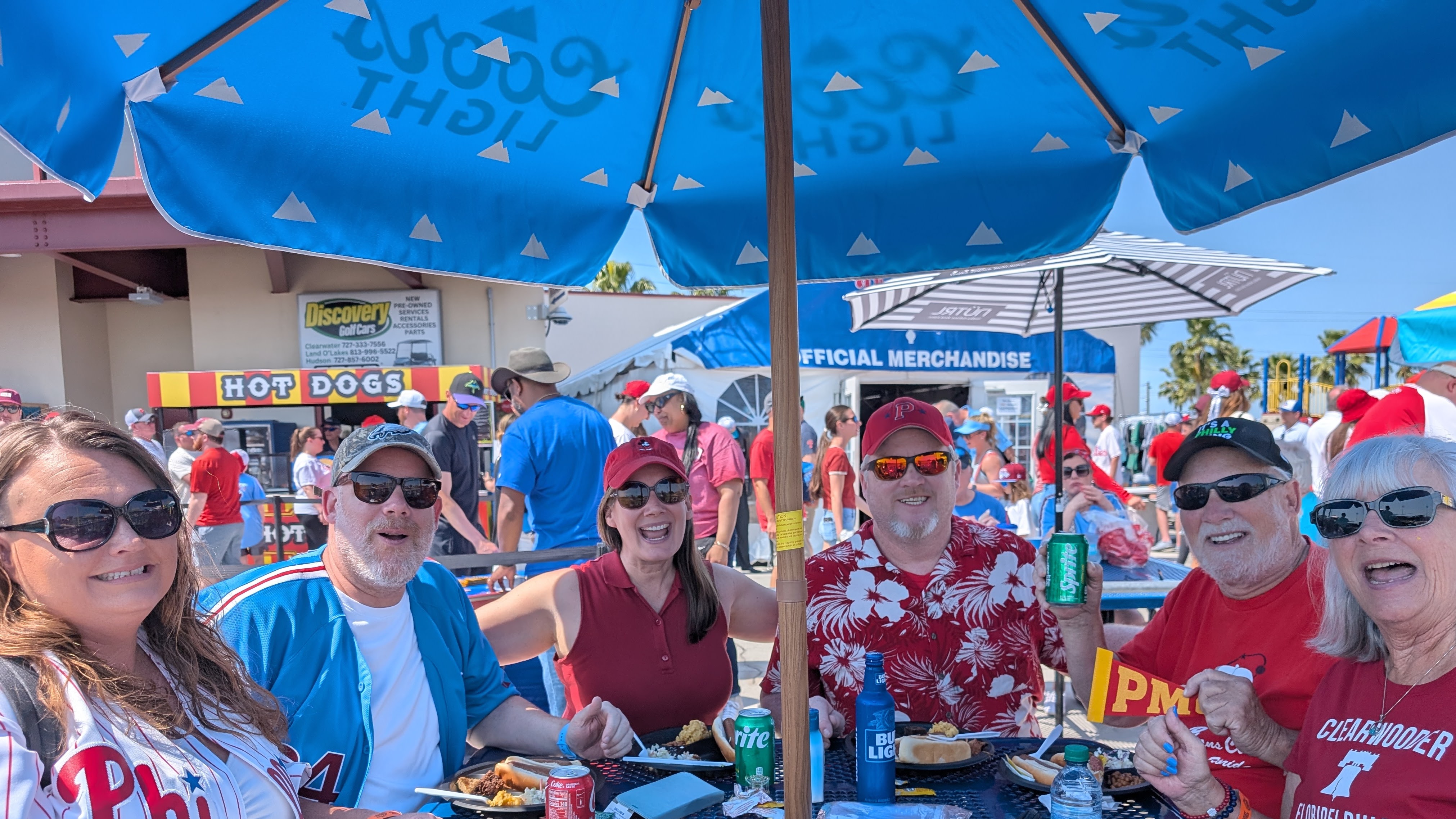 A group sitting around a table smiles for a photo