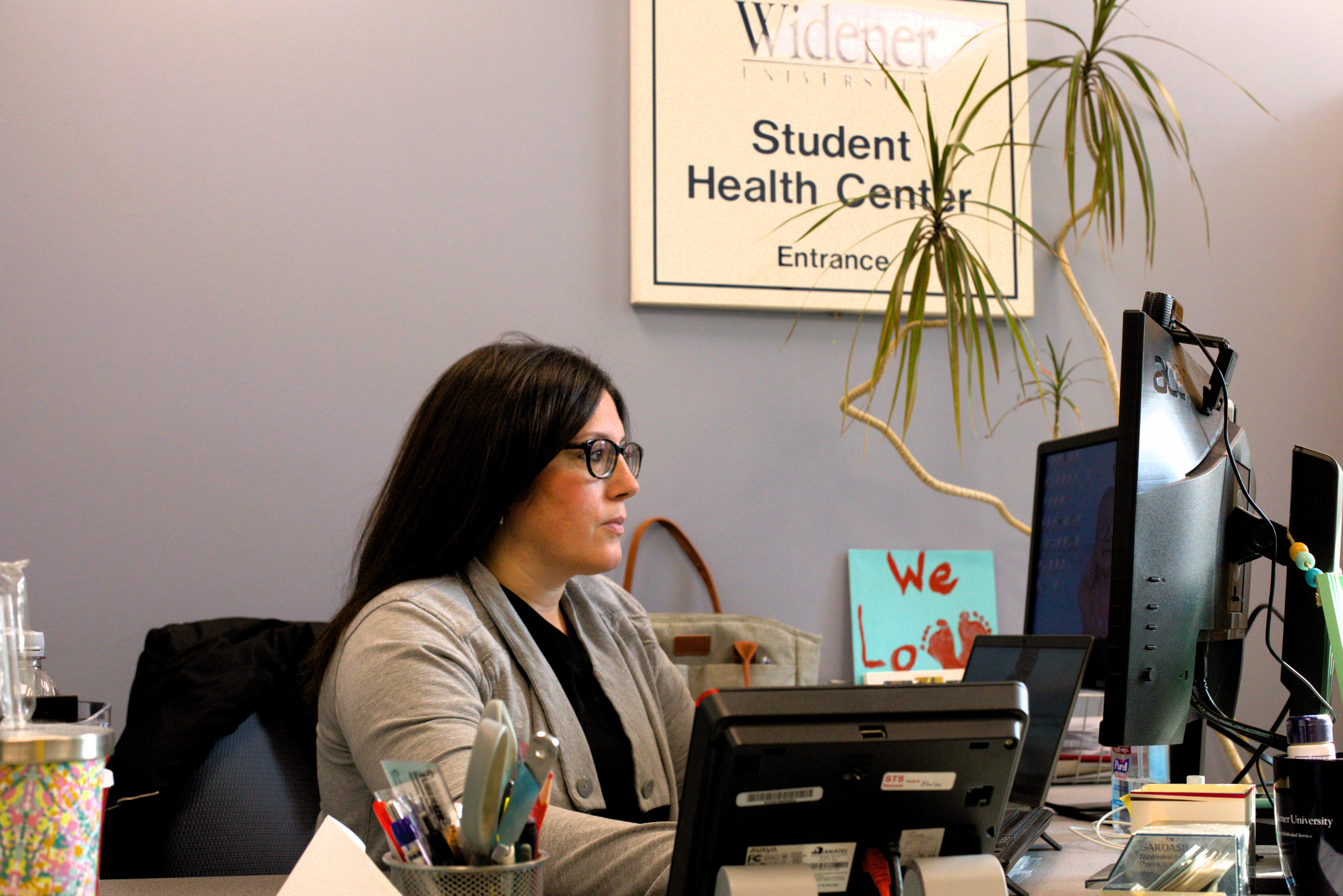 Lauren Thomas at her desk in the Student Health Center.