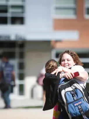 Widener students hugging on campus