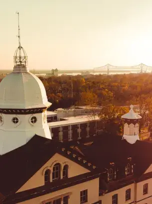 An aerial shot of the Old Main building at Widener at sunset