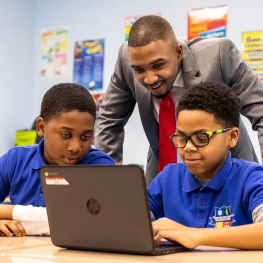 Michael Dixon working with students at a laptop