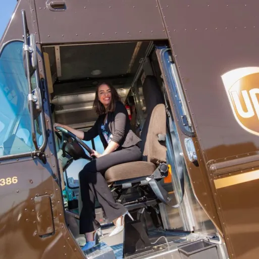 Aly Horton sitting in the driver's seat of a UPS truck 