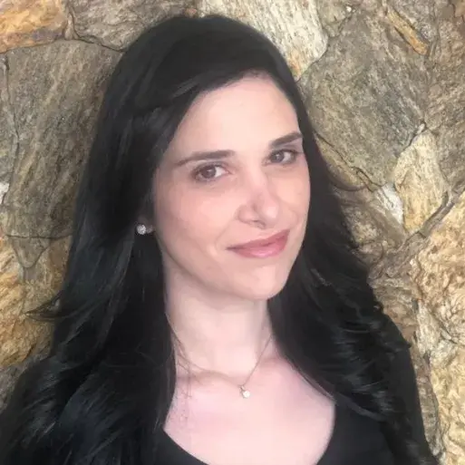 Karina Brasil stands in front of stone wall