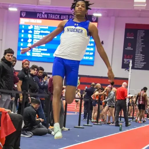 Matayo McGraw, wearing a Widener track uniform, in mid-jump