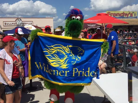 Philly Phanatic holding a Widener Pride flag