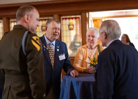 Tom Vossler and friends chatting at the alumni awards ceremony 