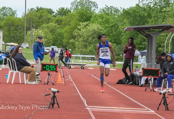 Matayo McGraw, wearing a Widener track shirt, runs on a track as he prepares to jump