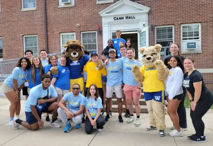 Move in day 2025 students mascots 960x640 Student volunteers pose on the steps of Cann Hall with the mascots welcoming new students to campus.