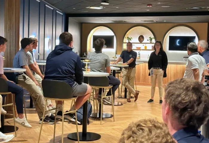 Faculty speak to students in a high-end hospitality setting at Subaru Park