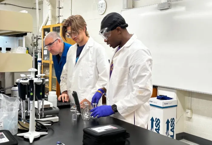 Students and faculty in the lab testing samples