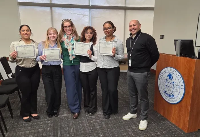 Four SBA students, a faculty member and a CO-OP supervisor standing together, posed during Honors Week