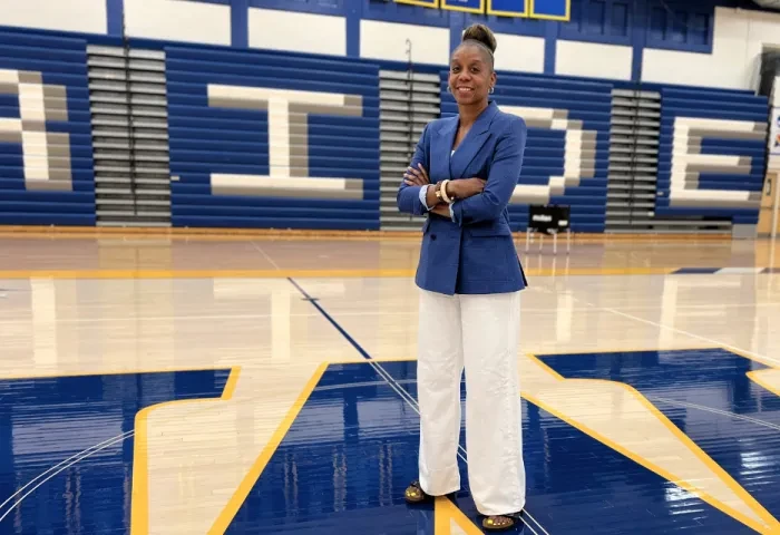 Athletics Executive Director Crystal Gibson stands center court in the gym