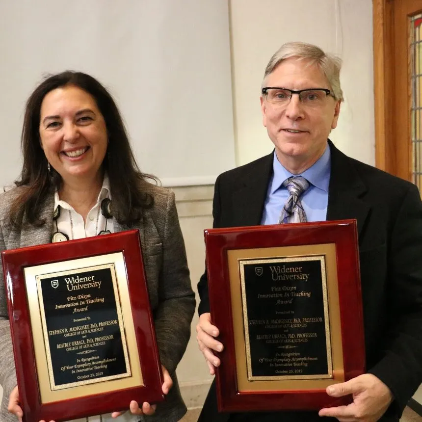 Beatriz Urraca and Stephen Madigosky hold their faculty awards