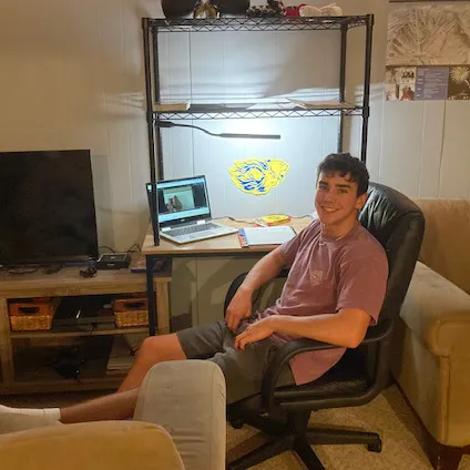 Student sitting at home workspace