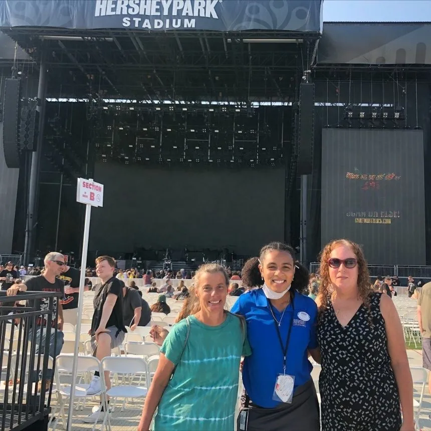 Donya Moore stands with two other people in the Hershey Stadium