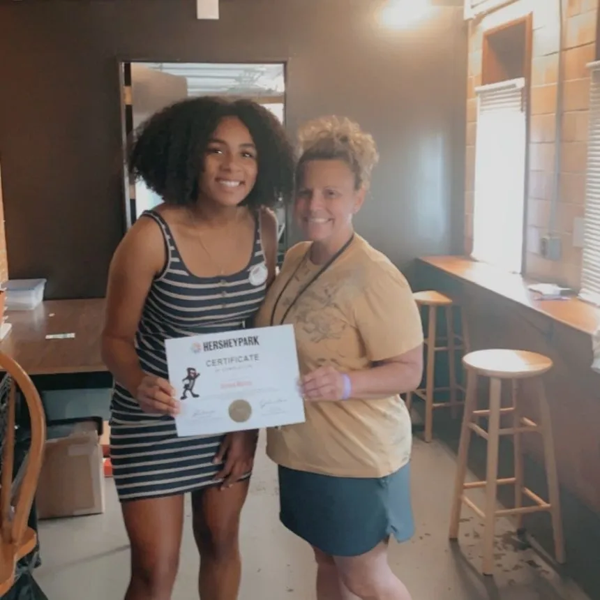 Donya Moore holds a Hershey Park achievement certificate