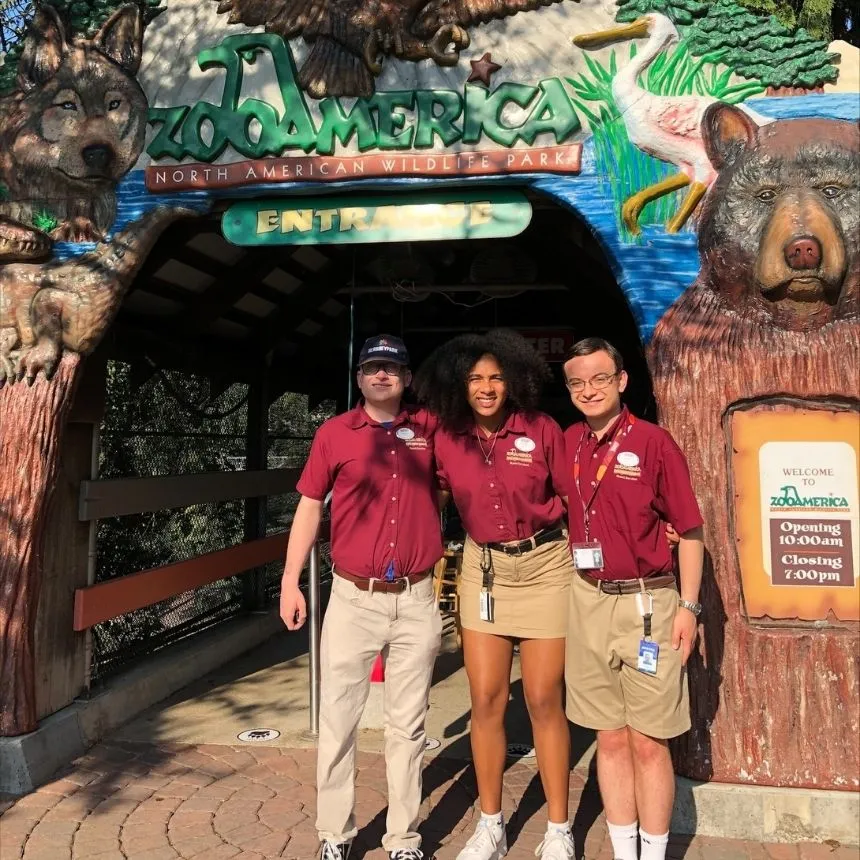 Donya Moore stands with two other interns in front of the Zoo America sign