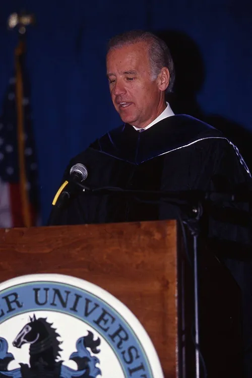 Joe Biden, in academic regalia, stands at a Widener podium