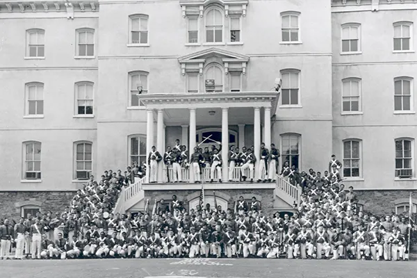 Black and white photo of cadet class standing in front of Old Main