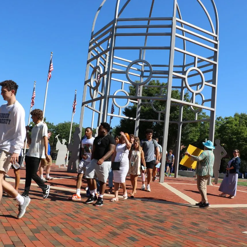 The Class of 2026 walk under the dome at Bown Garden.
