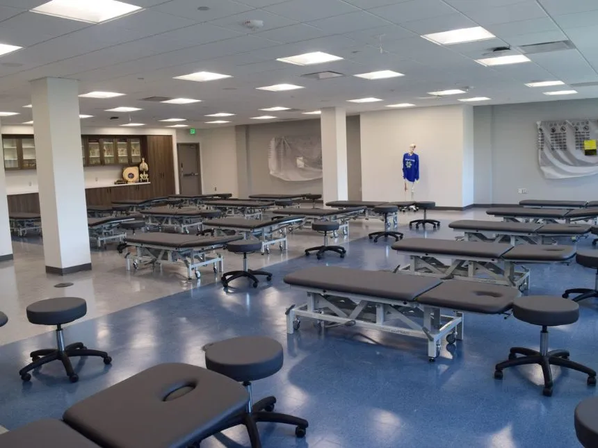 Patient exam tables are assembled in rows in the musculoskeletal lab