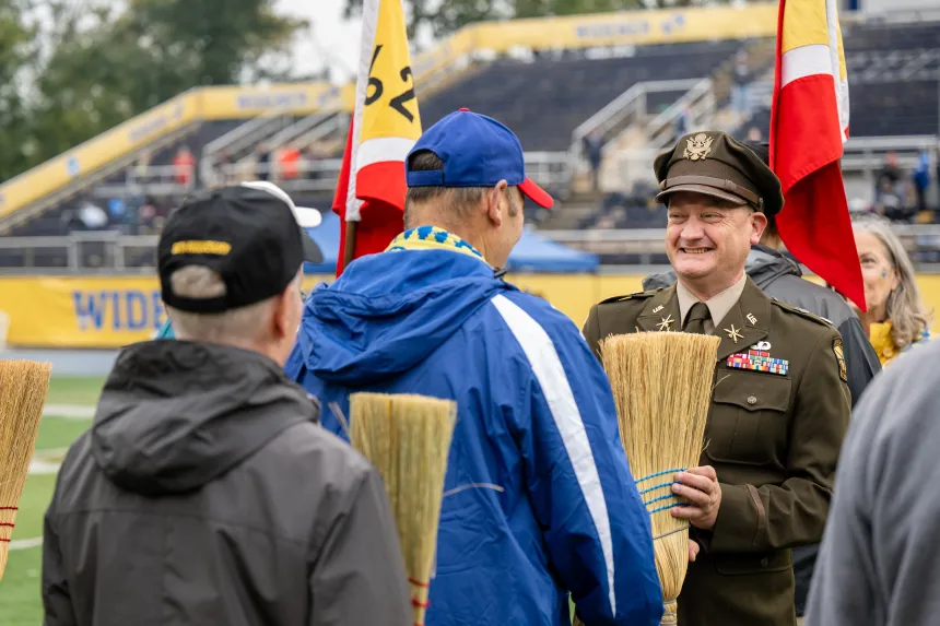 Alumni stand at attention for the annual broom drill 