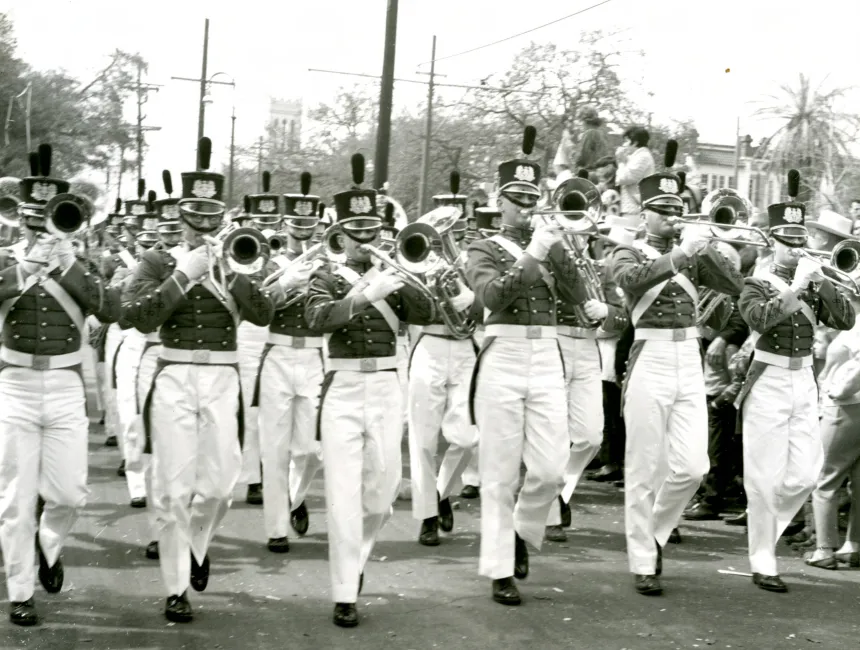 Black and white photo of PMC Band marching and playing in 1965