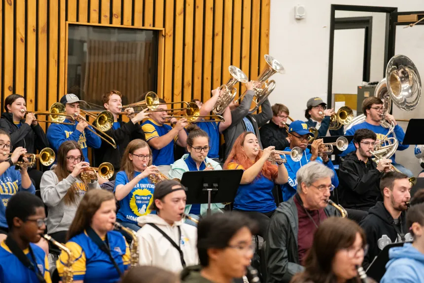 Large group of band members rehearsing in a room
