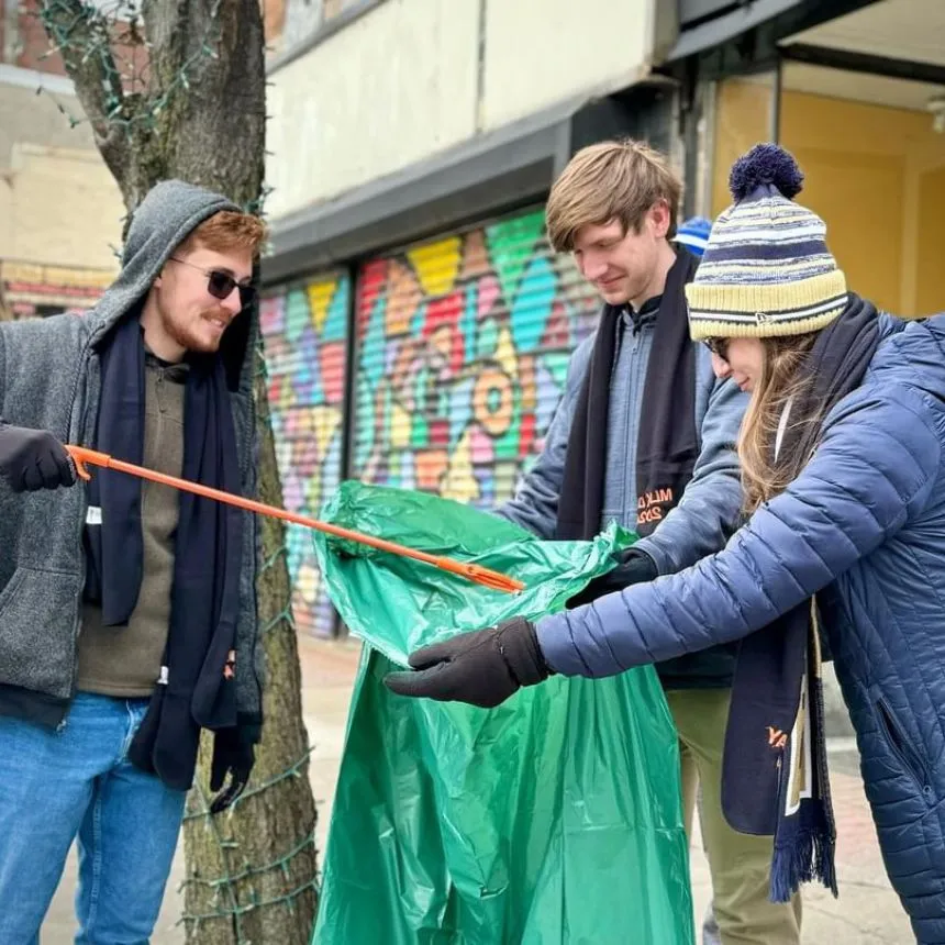 Students pick up trash as part of a community clean up project.