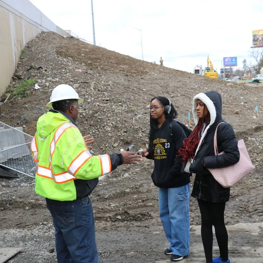 Students ask questions while visiting the I-95 bridge rebuild site.