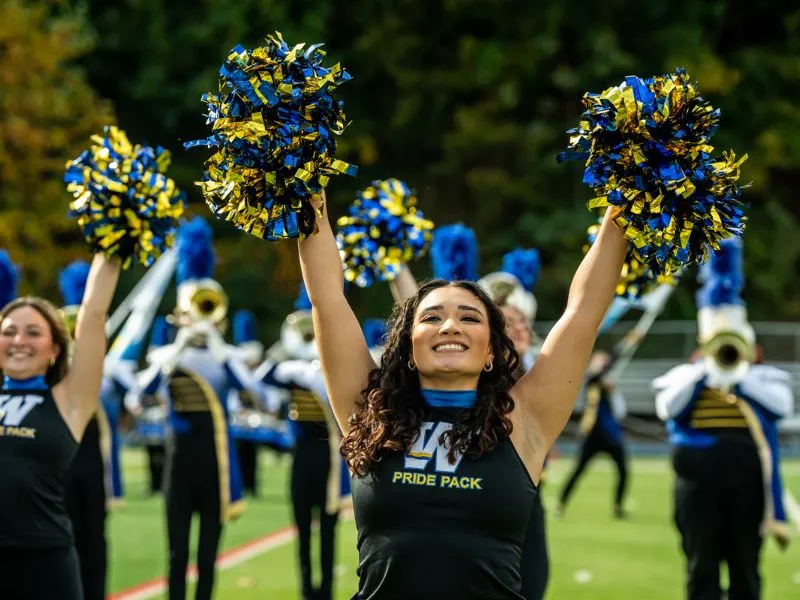 A Pride Pack dancer smiles mid-performance.