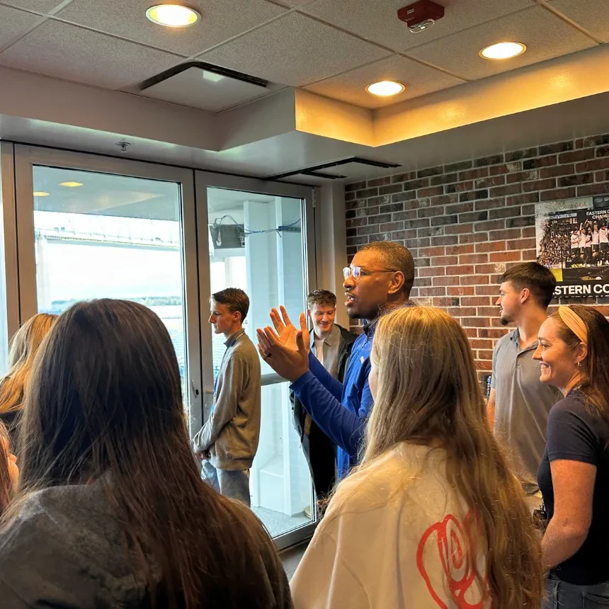Students listen to a presentation in a box suite at Subaru Park