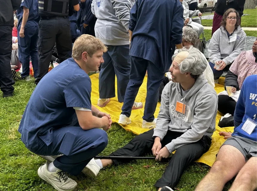 Nursing students treat a "patient" at a simulated disaster event on campus. 