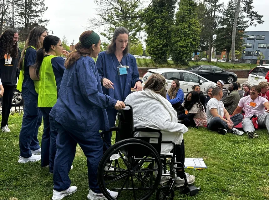 Nursing students treat a "patient" at a simulated disaster event on campus. 