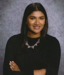 Jasmin Koshy smiles in her senior portrait