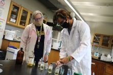 Assistant Professor Andrea Martin observes student Noah Smeriglio in the lab.