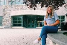 Samantha Business sits in from of the Quick Center