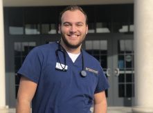 Jake Mergott poses in front of Founders Hall.