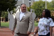 Tim Cairy walks with a female student on campus